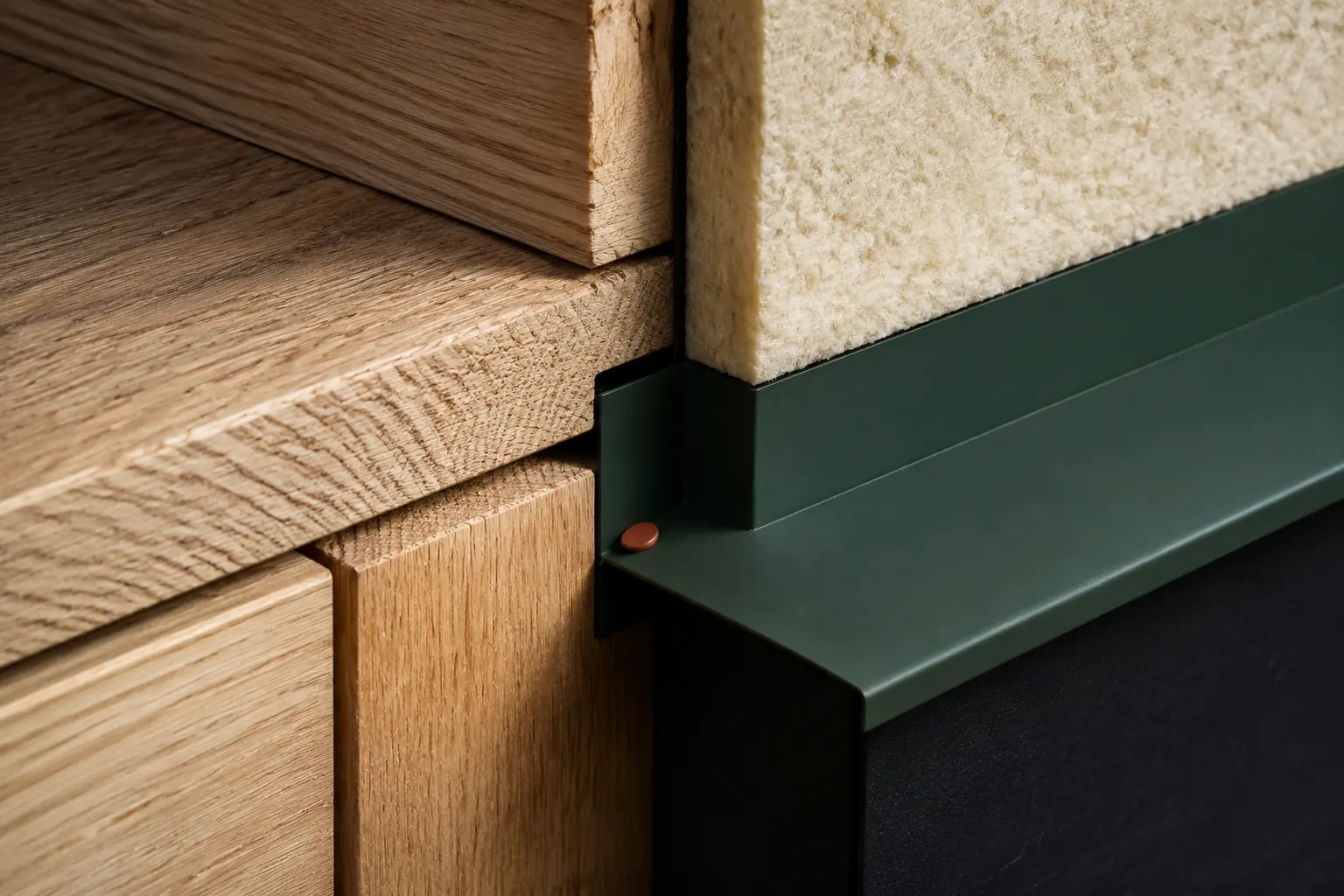 Precision timber joint meeting high-performance insulation and forest-green metal flashing