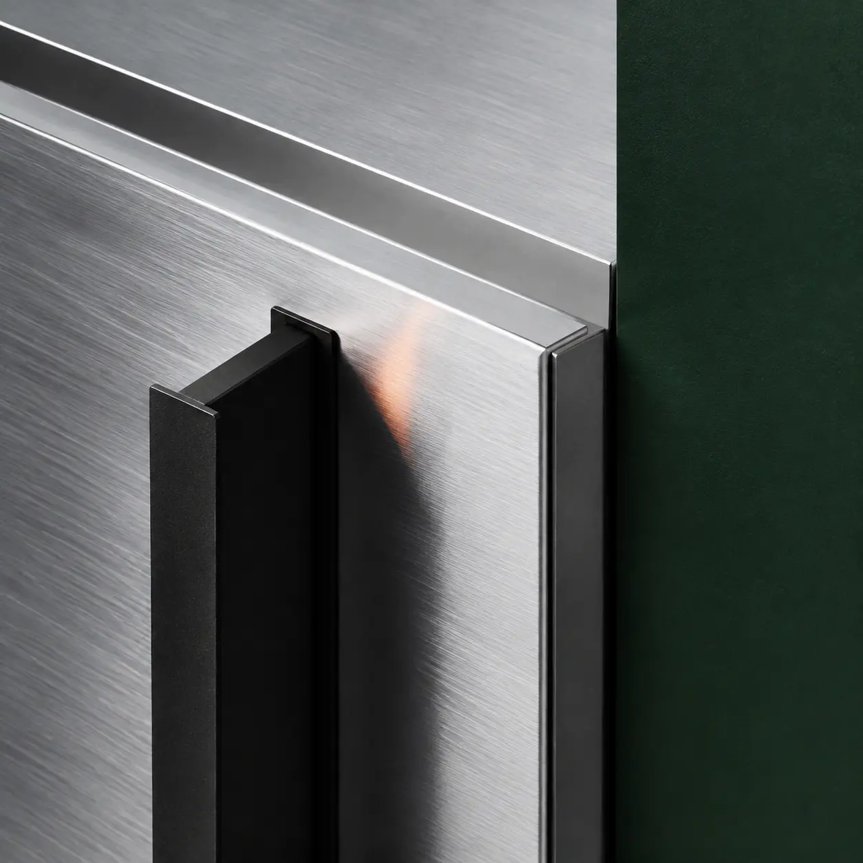 Brushed aluminum edge detail beside matte-black hardware