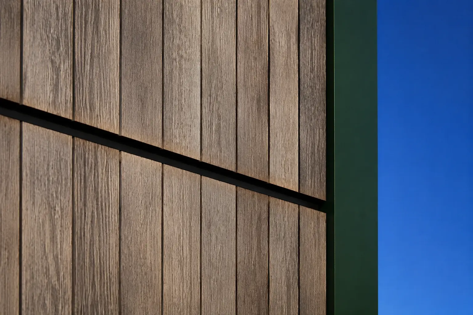 Weathered timber cladding with refined natural patina and precise detailing