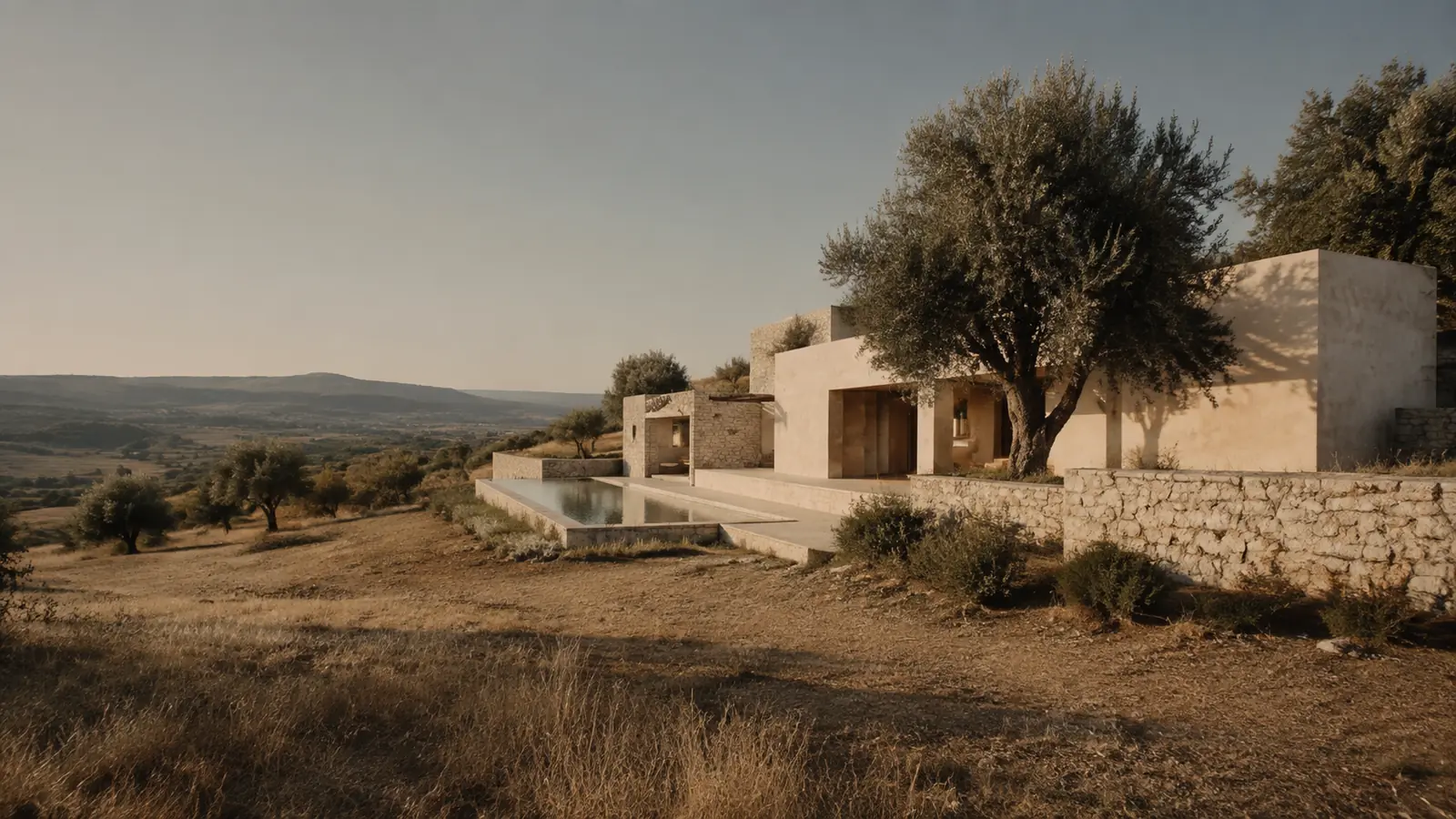 Aster House integrated into a Mediterranean hillside at golden hour